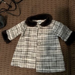 Newborn black and white jacket with faux fur trim.